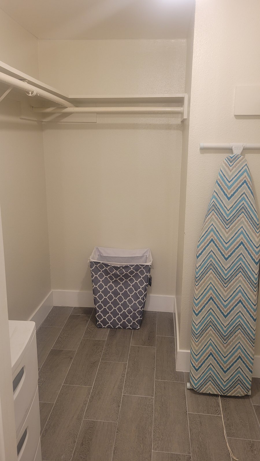 2nd Bedroom's Walk in Closet equipped with a full ironing board, iron, and laundry basket