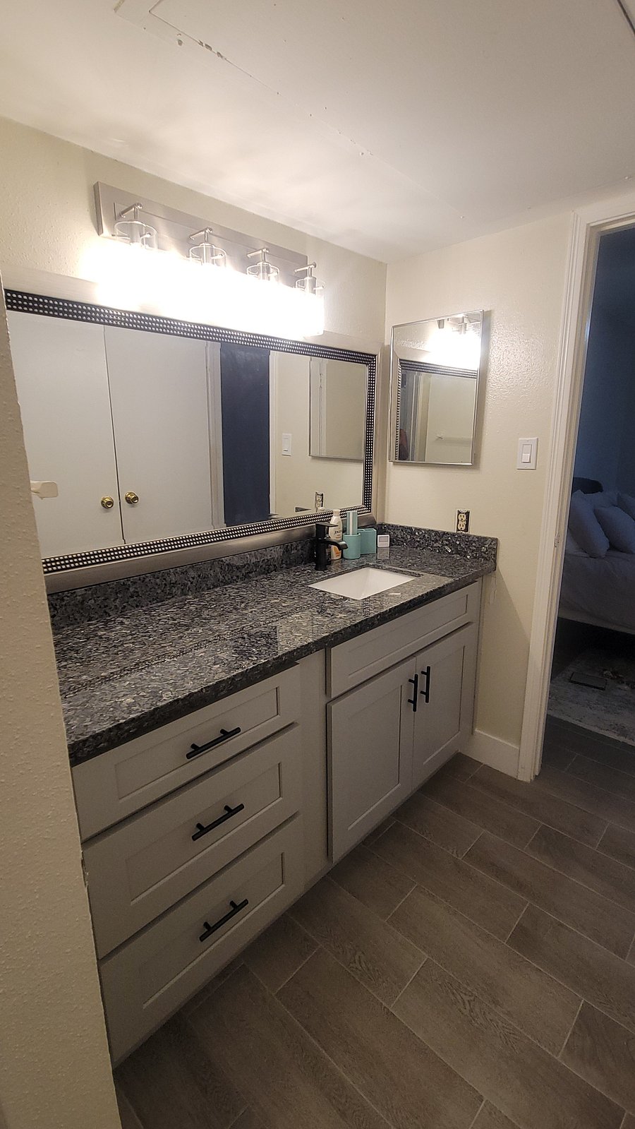 2nd bedroom's in-suite bathroom vanity equipped with plenty of storage, counter space, and medicine cabinet.
