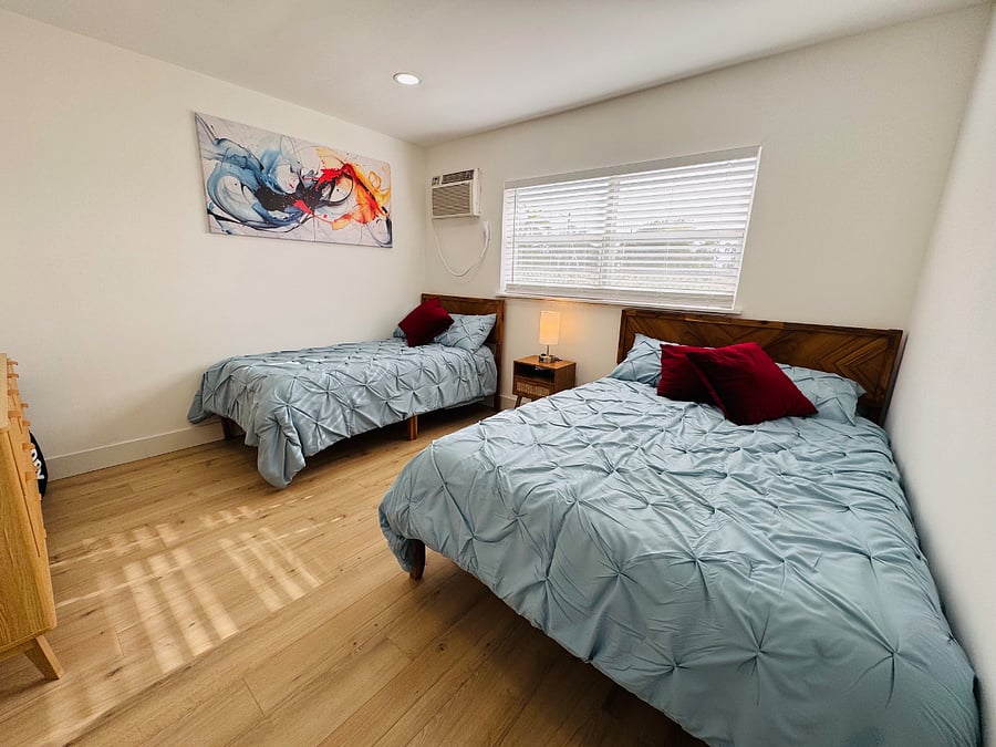 The second bedroom is bright and comfortable, featuring ample closet space and stylish decor for a restful stay.