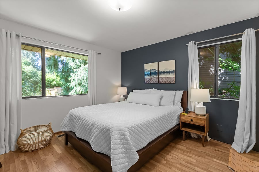 bedroom with queen bed, two closets with Elfa system, beautiful view of trees