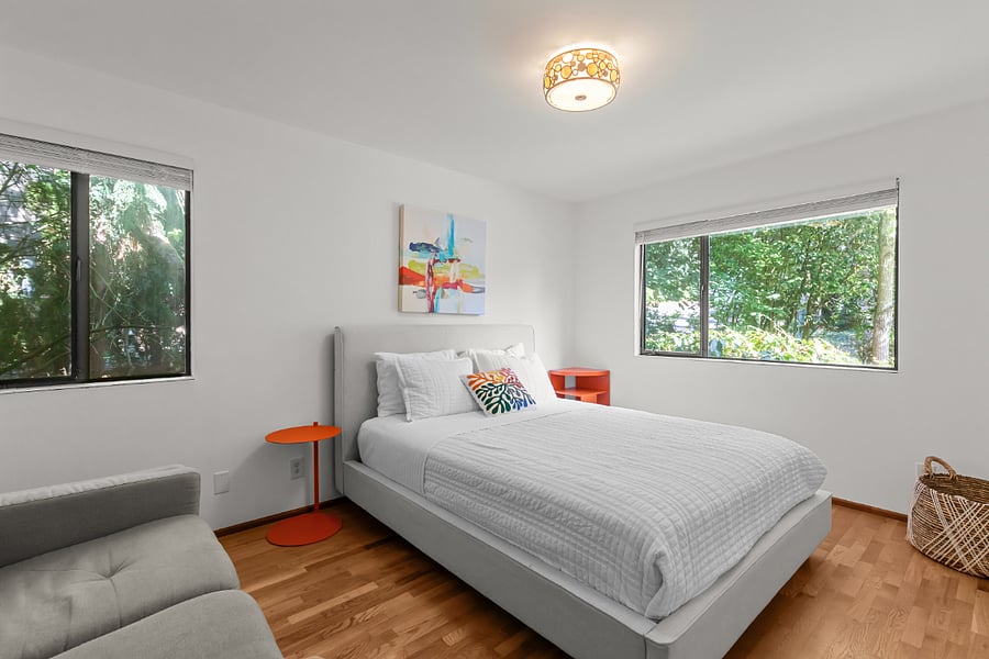 largest bedroom with queen bed, couch and large closet with Elfa system