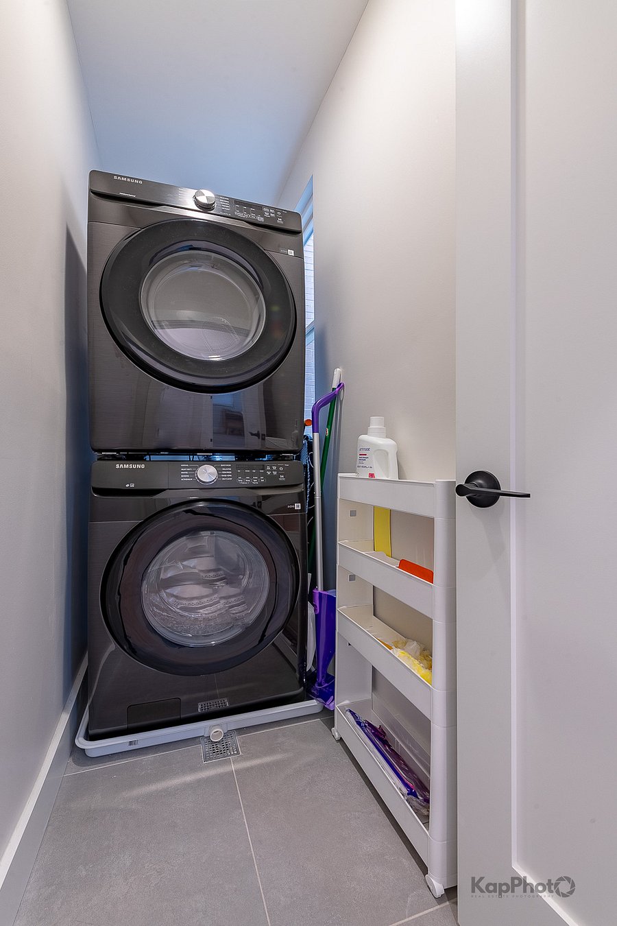 In unit washer and dryer with cleaning supplies. 