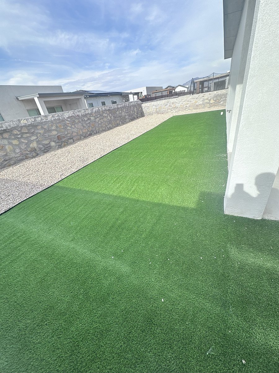 Backyard with artificial turf and garden stones