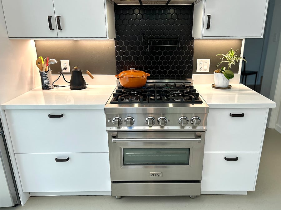 New kitchen with quartz countertops and modern appliances.