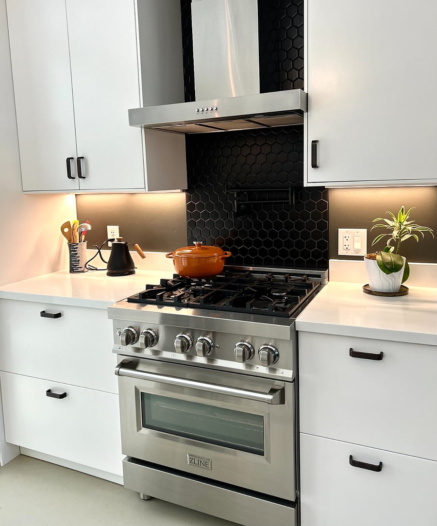 New kitchen with quartz countertops and modern appliances.