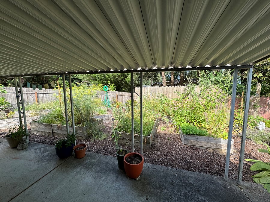 Covered back patio that looks out on the garden space. Enjoy your morning coffee with the birds.