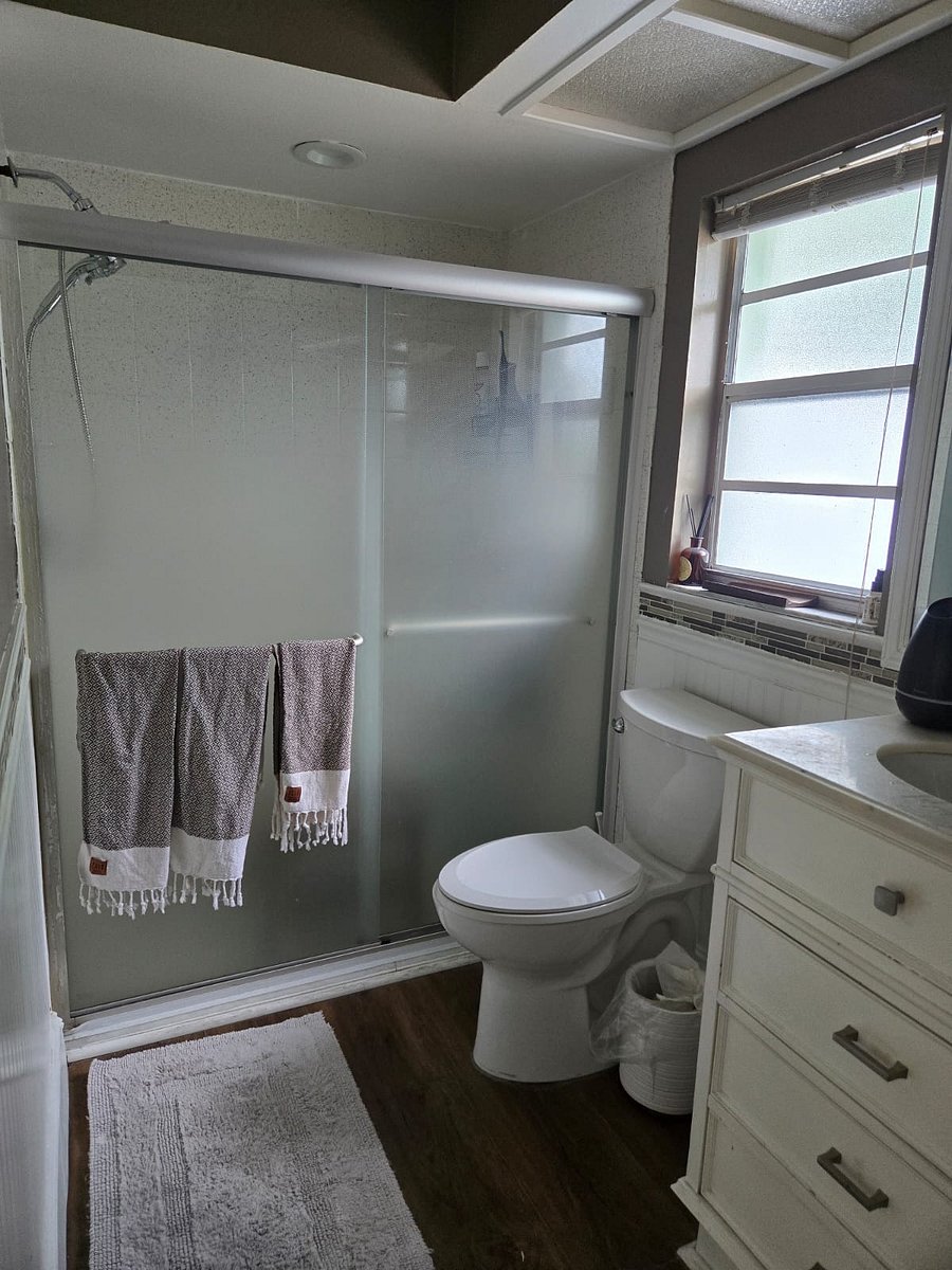 Clean shared bathroom with a walk-in shower, shared with 1 roommate (Room E).