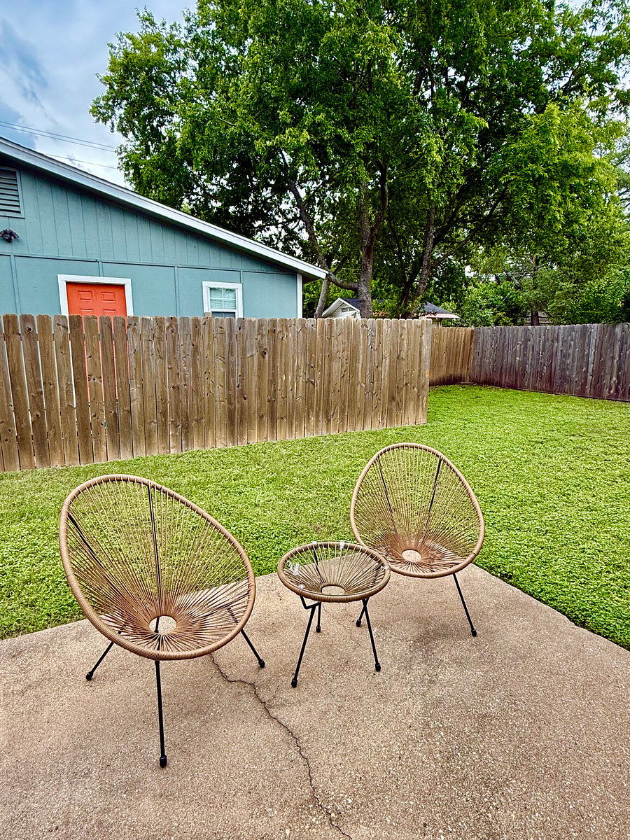 Fenced in backyard with seating