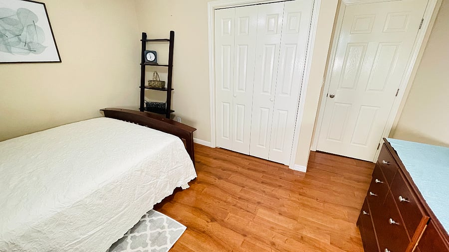 2nd bedroom. queen bed, window faces south closet view