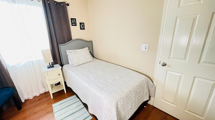 3rd bedroom twin size bed and trundle bed underneath north facing window