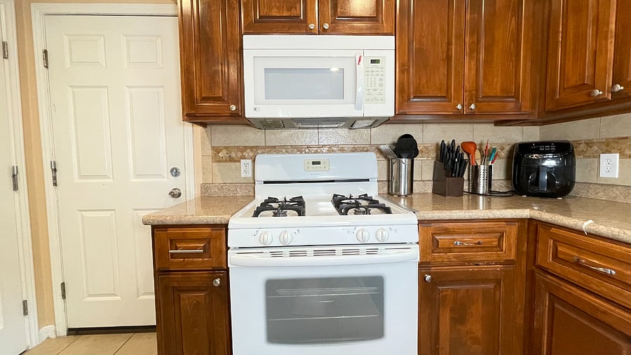 Kitchen gas stove, fridge with ice maker, dishwasher, bar height counter.jpeg
