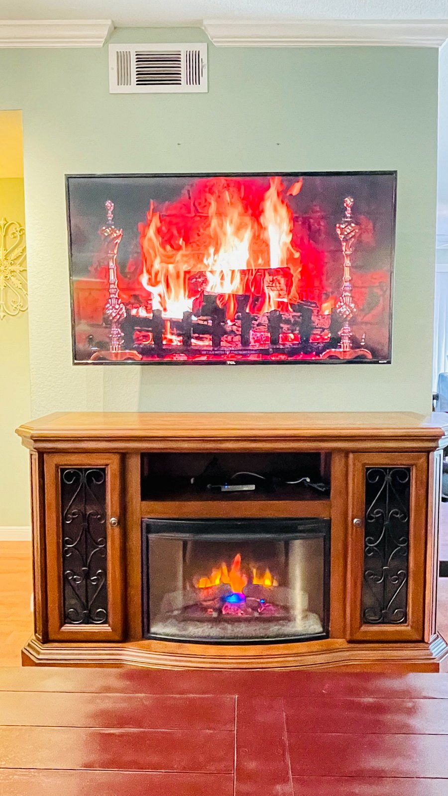 Living room with 55 inch Roku Tv with apps faux fireplace