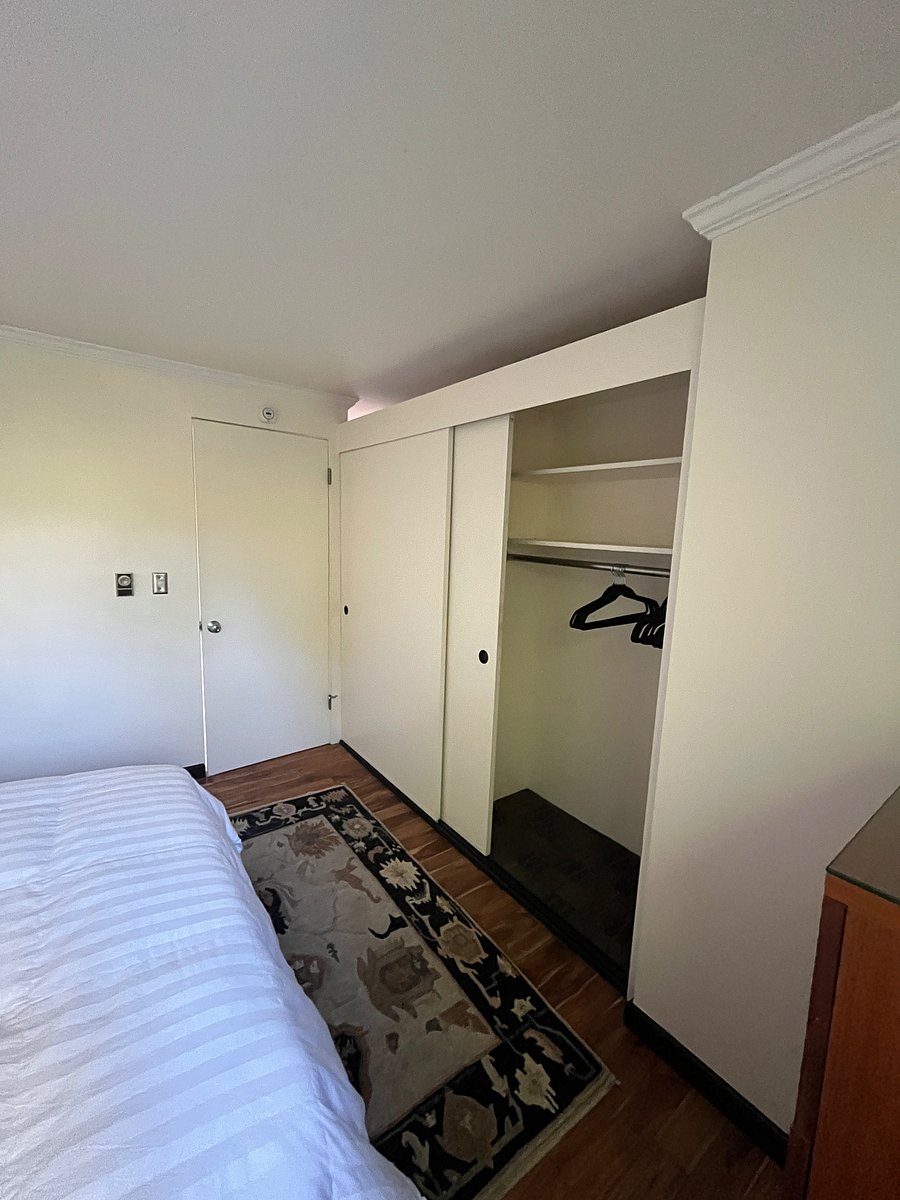 Bedroom closet with sliding doors.