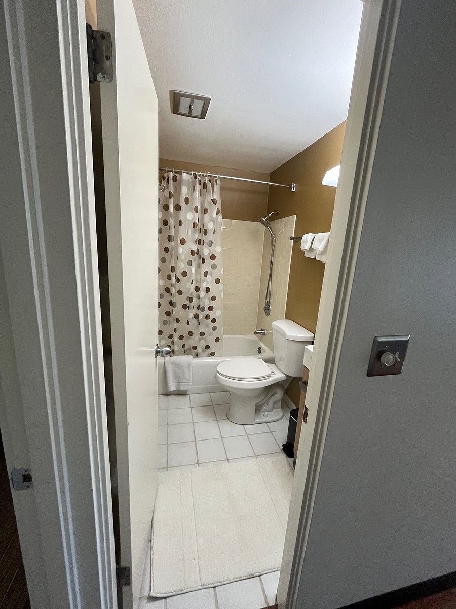 Bathroom with sink, tub, and toilet. Medicine cabinet mirror above the sink. All new towels.
