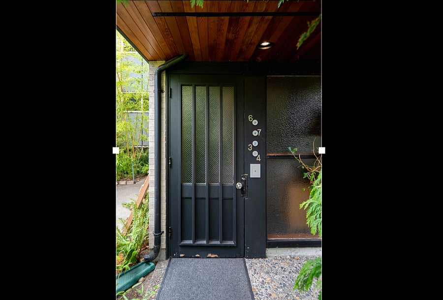 Front door to the property on the South side of the building with a covered entrance.