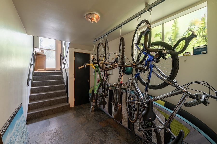 Bike rack area for the building located inside the front door, down the stairs.