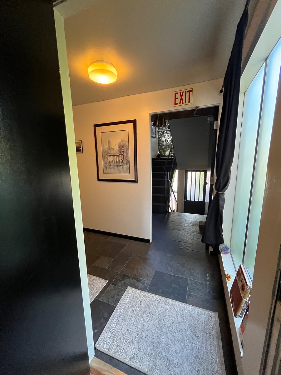 View exiting Unit 3 Apartment toward hallway and stairs towards Front Door of building.