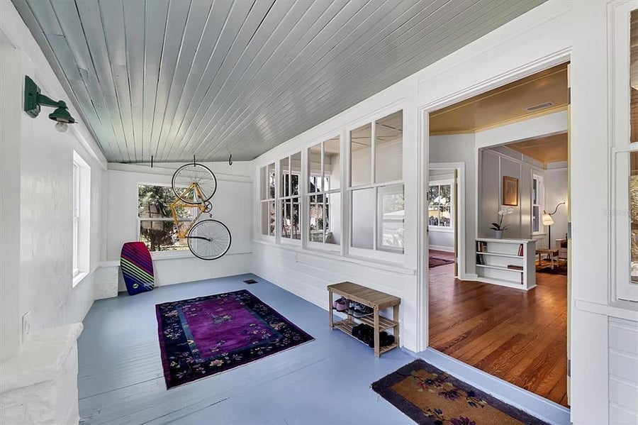 Enclosed front porch. Now a sitting room or playroom. Can also move desk here to convert to separate office space.