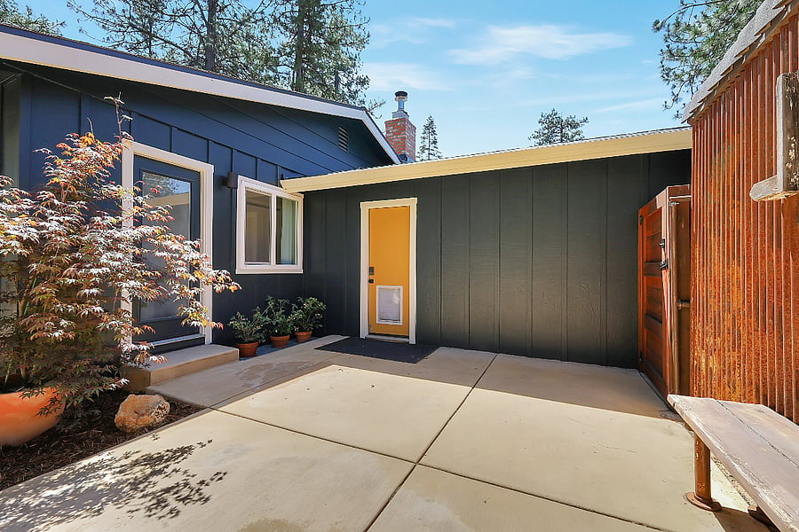 Backyard/patio. Yellow door accesses garage.