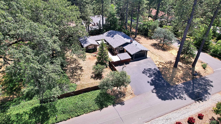 fenced in yard, driveway with parking and 2 car garage