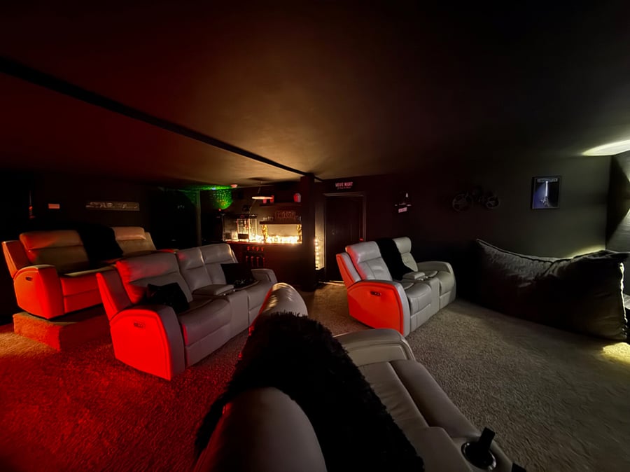 Movie room with 4 double recliner seats that seat 8 people 