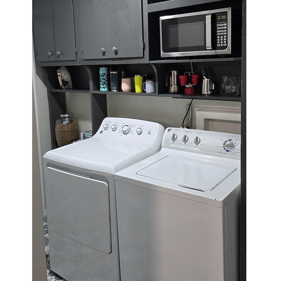 Full size washer and dryer in the utility as well as the microwave, iron and ironing board, and cleaning supplies.