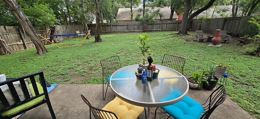 There are dining and seating areas on the back porch. There is a chimenea and seats under the large oak, a hammock under the cedars, seating in the back corner with the purple heart, and a side garden leads to the front yard.