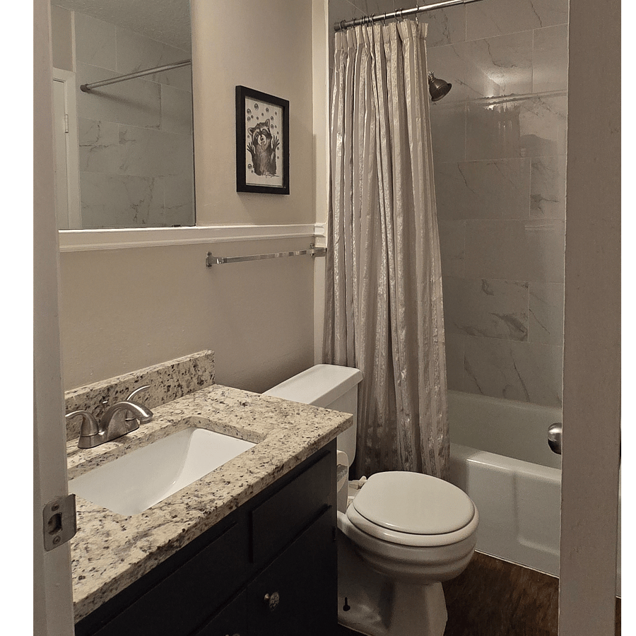 Full bath with shower and tub. This room opens to the hall and primary bedroom.