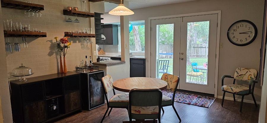 The dining room has a dry bar area with a beverage fridge and bar accessories. There is also a stereo with radio, cd, and aux cord.