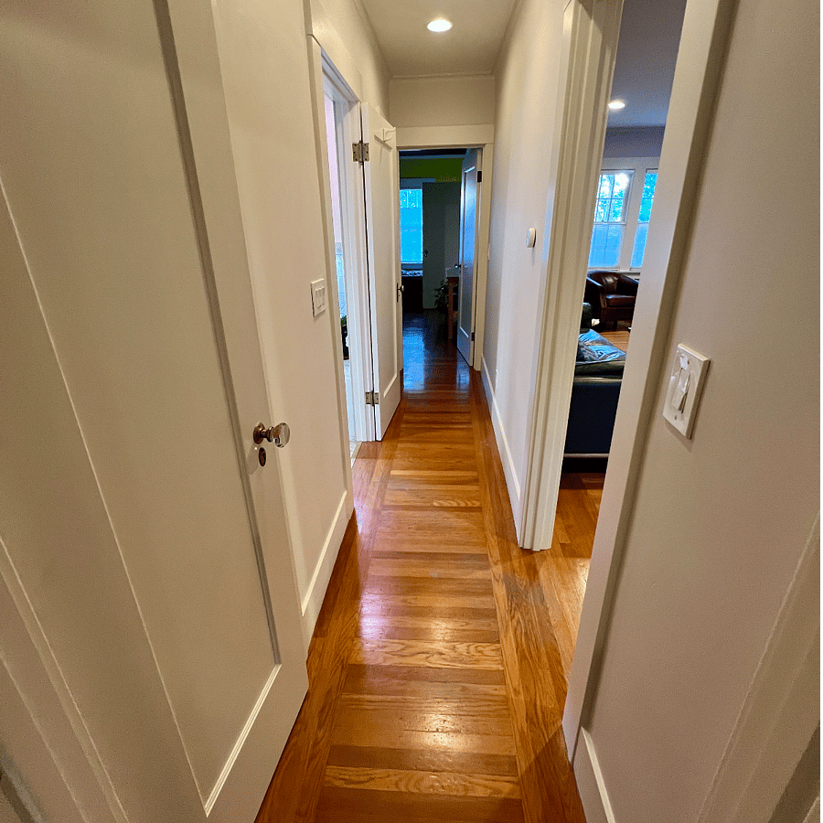 Hallway between the bedrooms includes two closets for additional storage.