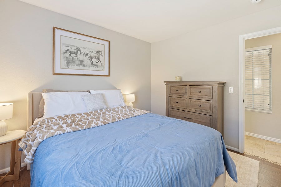 Bedroom 2 with a queen bed, closet, dresser and 2 nightstands