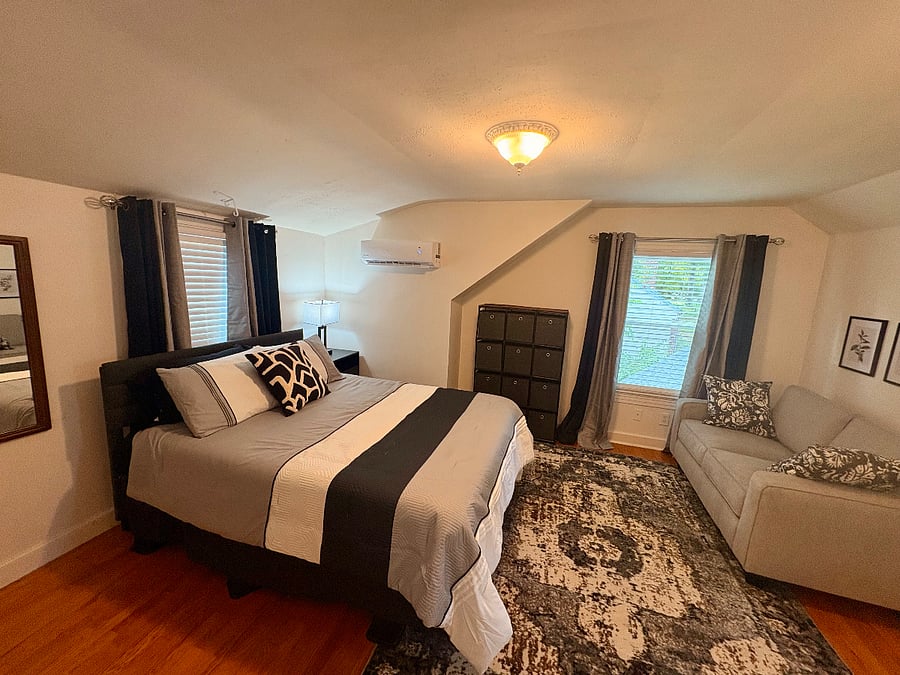 Bedroom #3 - queen bed, multiple closets, mini-split for personalized heating and cooling, desk, loveseat and cozy dormer area for reading and dreaming