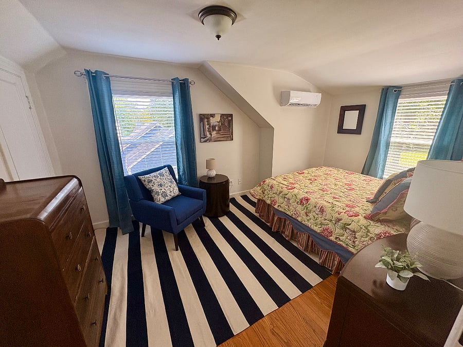 Bedroom #2 - queen bed, closet, dressers, chair and side table for reading or just relaxing, mini-split for personalized heating and cooling