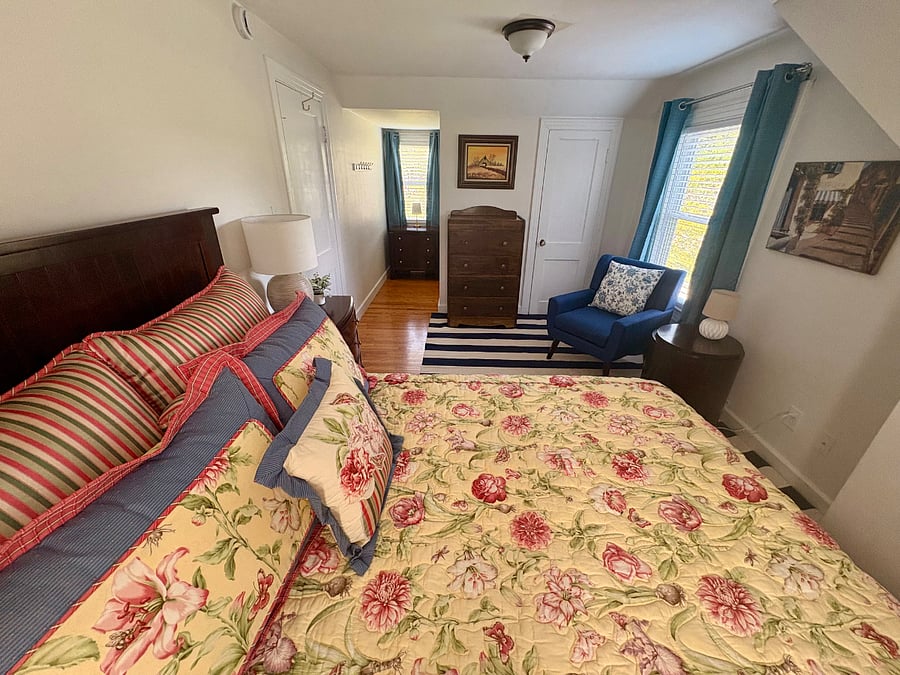 Bedroom #2 - queen bed, closet, dressers, chair and side table for reading or just relaxing, mini-split for personalized heating and cooling