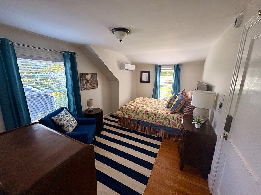 Bedroom #2 - queen bed, closet, dressers, chair and side table for reading or just relaxing, mini-split for personalized heating and cooling