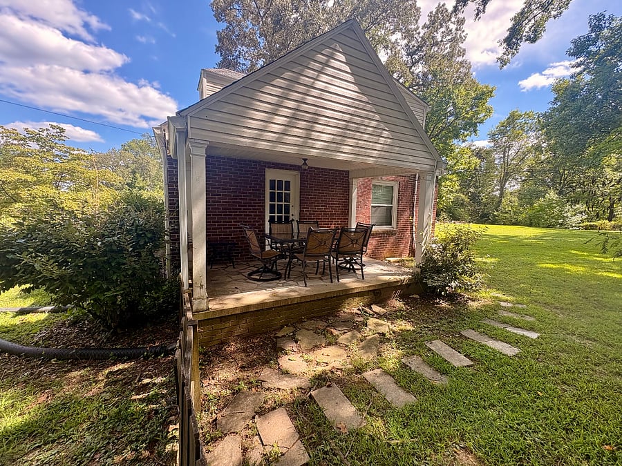 Cozy covered side porch - has table & chairs to accommodate 6 people. Perfect extra space for entertaining or relaxing