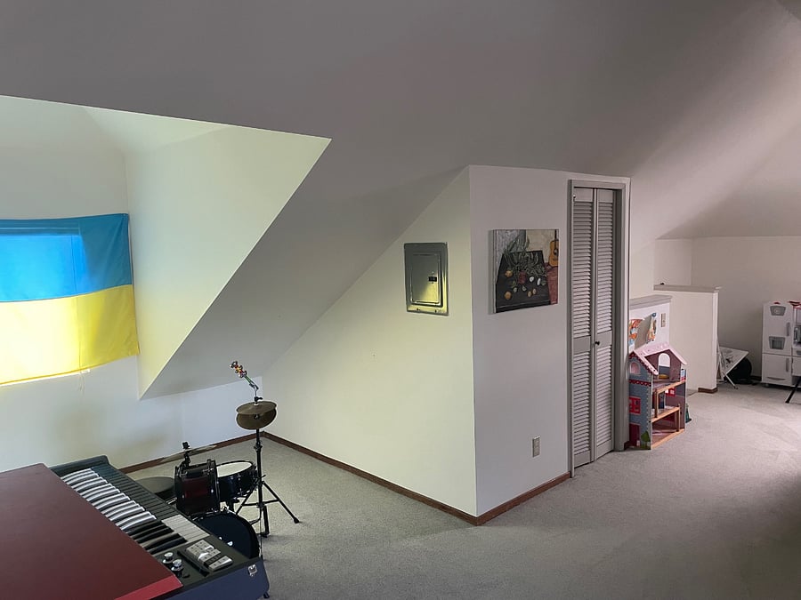 Big main room, this shot is opposite the office nook, and looks out to the smaller room at the top of the stairs. Musical instruments have been moved since pic taken. Flag gone and window faces west.