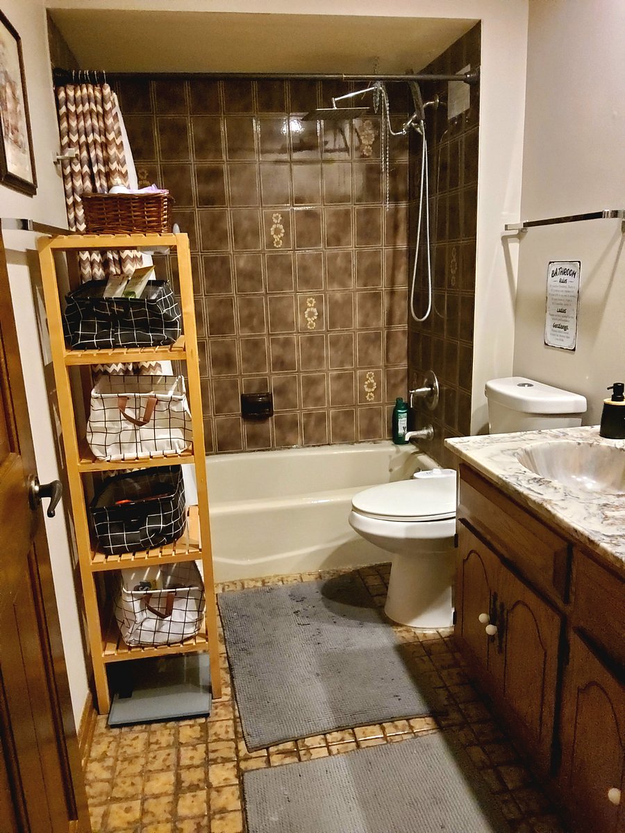 Shared bathroom with a shower/tub combination, double sink, fresh towels, and toiletries provided (biweekly professional cleaning).