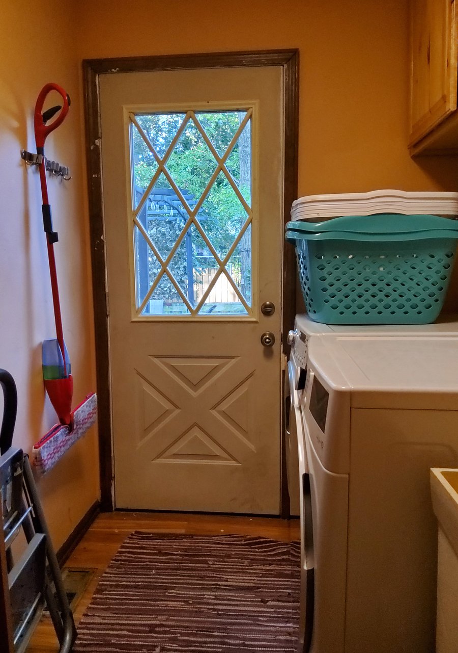 Laundry room with washer and dryer available for tenants, laundry baskets provided.