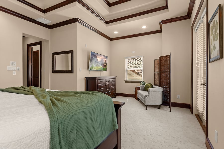Master sitting area with TV, and access to private balcony