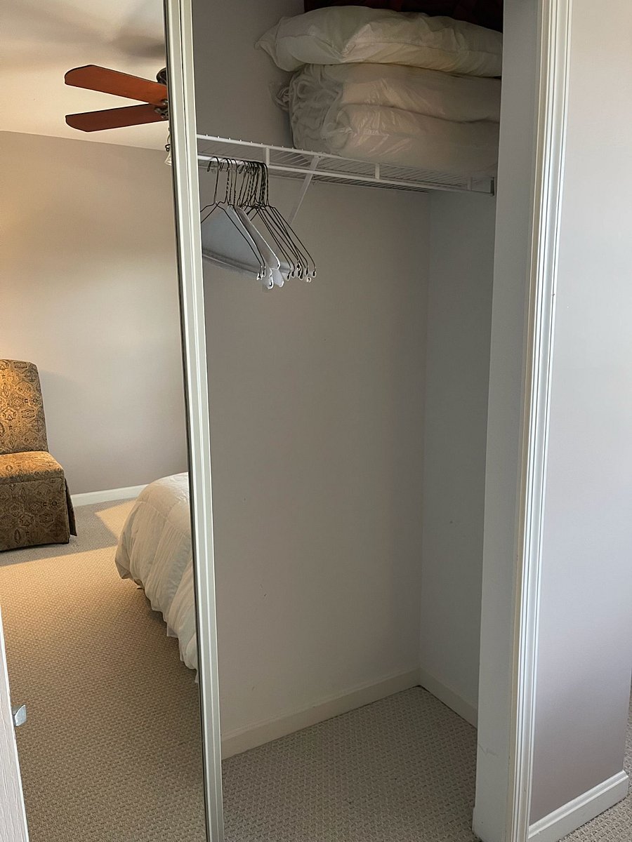 Large closet with sliding mirrored doors