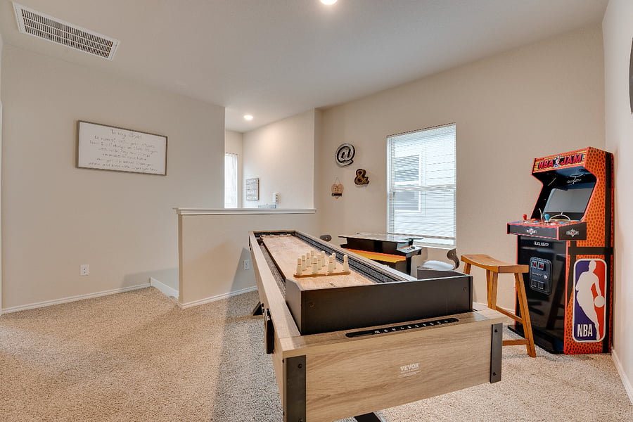Shuffle board and arcade games in the game room
