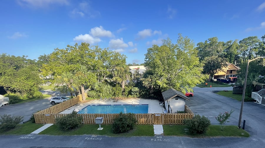 View of pool and additional parking area from Master bedroom window