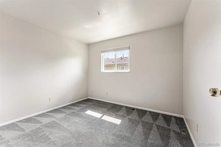Picture of the second bedroom unfurnished to show potential for an office space if that is preferred