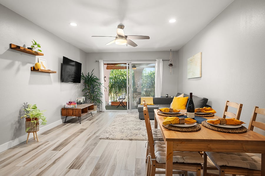 Living/Dining room with large TV and access to Balcony