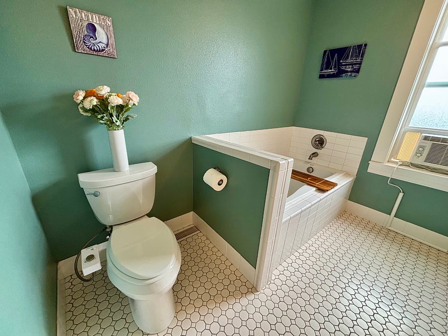 Private bathroom with bidet toilet, soaking tub, and separate shower.
