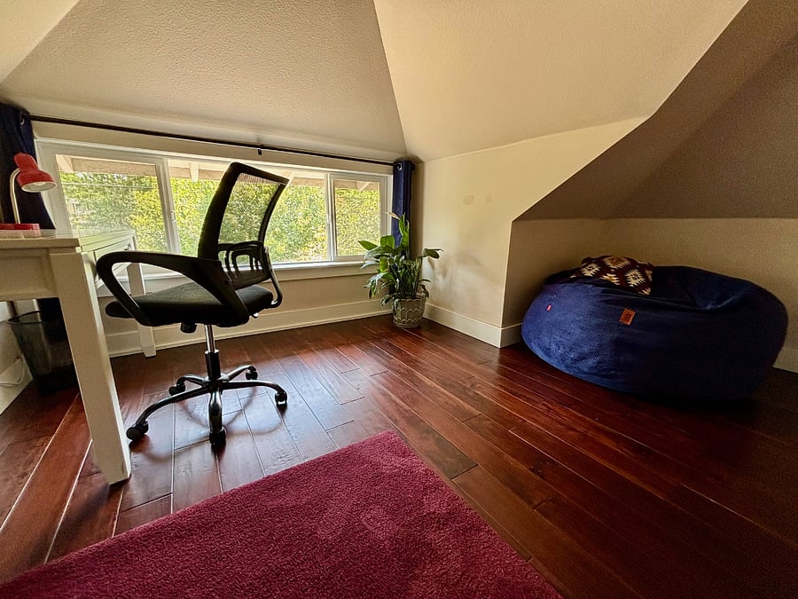 Office nook with bean bag chair that folds out into a queen-size mattress, plus a south-facing window with blackout curtains.