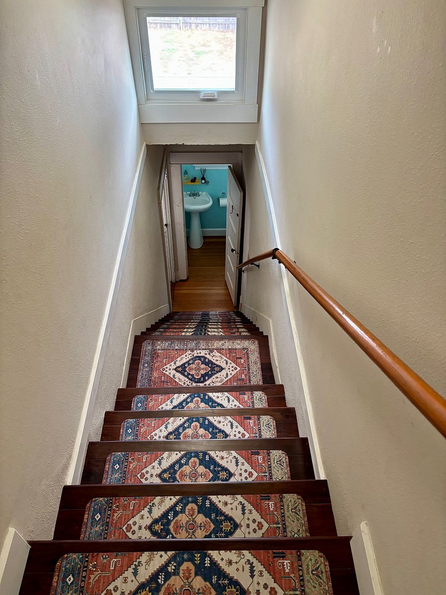 Stairs to your private suite and the shared spaces below. Separate locking doors to the bedroom and bathroom are at the top of the stairwell.