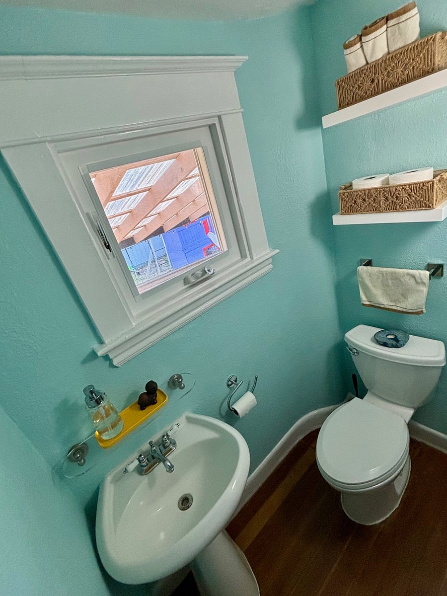 Shared half bath on the lower level, located between the stairwell and laundry room.
