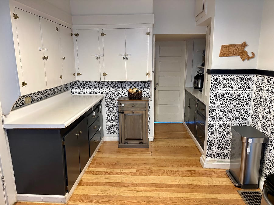Shared lower-level kitchen connected to the laundry room, fully stocked with cookware and small appliances including an Instant Pot, air fryer, blender, food processor, toaster oven, KitchenAid mixer, and more.
